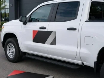 Custom magnetic vehicle sign installed on the door of a white work pickup truck