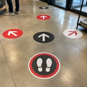 Custom directional and foot-position floor graphics installed on polished concrete