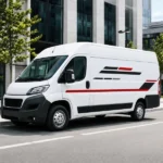 Custom red and black vinyl vehicle lettering installed on a white commercial van