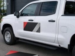Custom magnetic vehicle sign installed on the door of a white work pickup truck