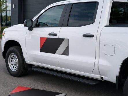 Custom magnetic vehicle sign installed on the door of a white work pickup truck